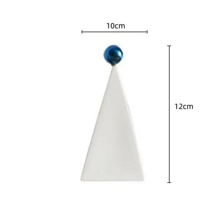 A sleek white ceramic geometric triangle ornament with a glossy blue spherical top for living room decorbites decor