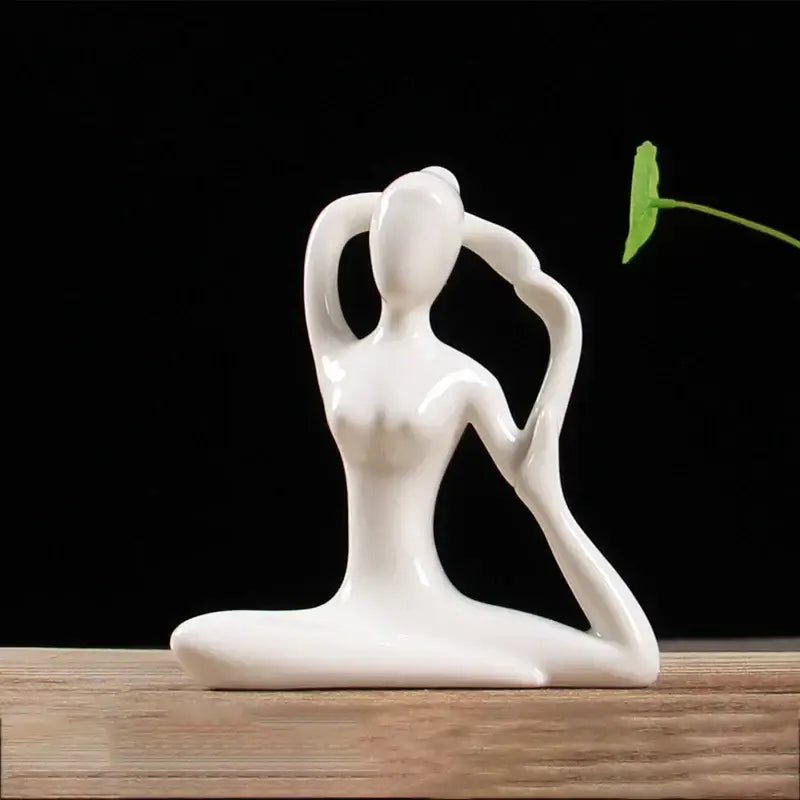 White ceramic abstract yoga figure of a woman in a graceful pose for living room decor by decorbites