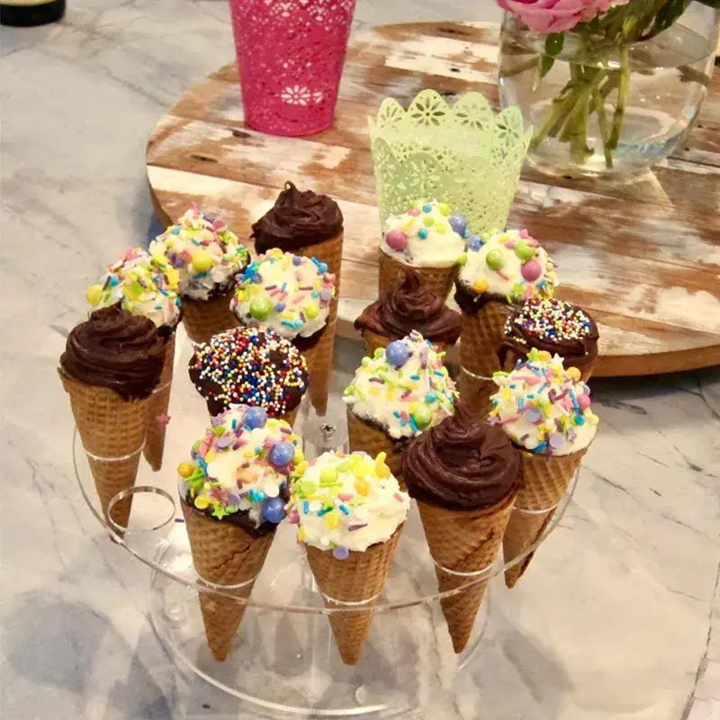 Acrylic ice cream cone holder displaying mini ice cream cones with chocolate and vanilla frosting and colorful sprinkles