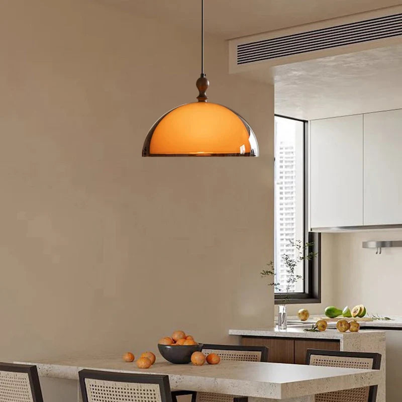 Warm amber glass pendant light with polished brass finish and sleek dome shape featured in acrylic pendant light dark wood lampshade