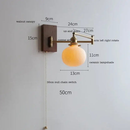 Adjustable brass wall sconce with warm-toned ribbed ceramic lampshade and decorbites copper arm on walnut canopy