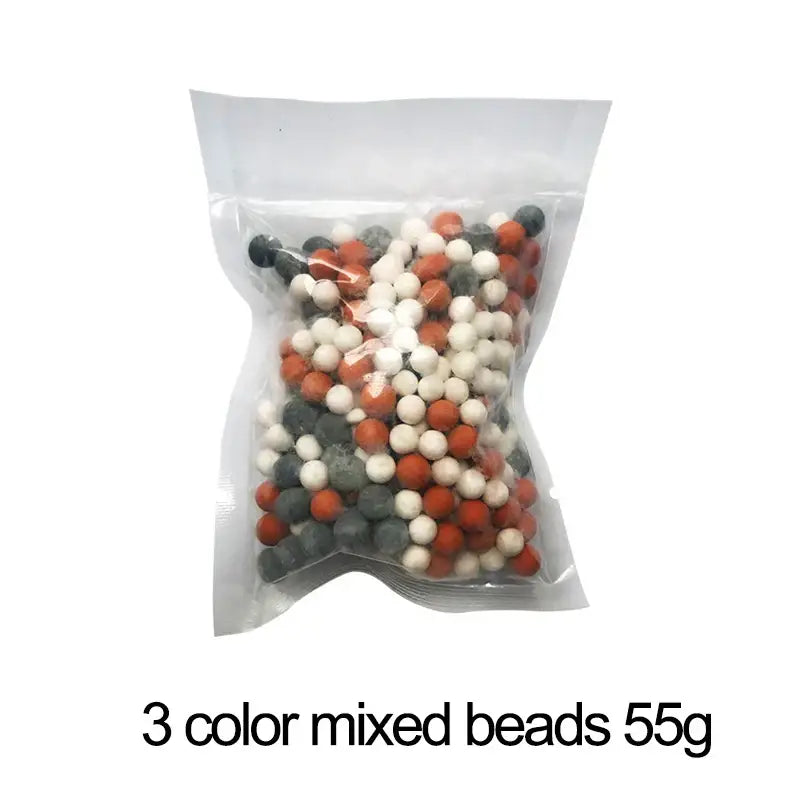 A clear plastic bag with 55g of mixed orange white and gray filtered beads for decorbites adjustable jetting shower head