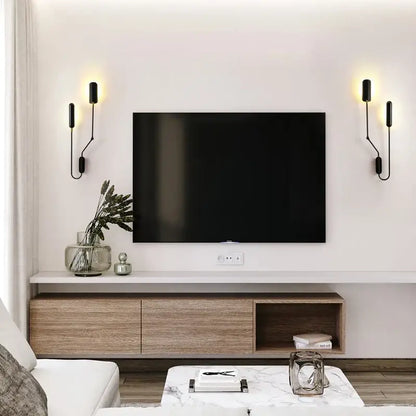 Black flat-screen television mounted on white wall showcasing decorbites adjustable retro wall lamp for bedroom reading
