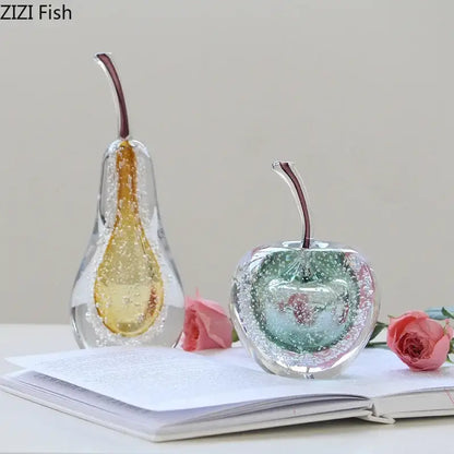Aesthetic green and gold glass fruit sculpture desk ornament featuring amber bubble pear and teal interior apple with dark stems