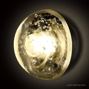 A warm amber and gold textured crystal led wall lamp with swirling glass shade from decorbites for bedroom decor