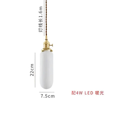 Amber and cream geometric glass pendant light with sleek white ceramic and gold fixture for modern dining room interiors