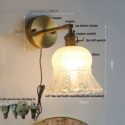 Vintage-style copper wall light fixture with textured frosted amber flower crystal glass shade and pull chain for bedroom