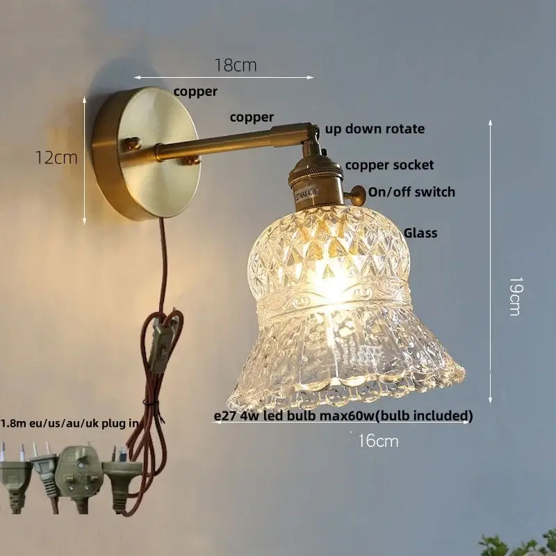 Antique brass-finished wall light fixture with faceted clear glass shade and amber flower crystal design for bedroom use