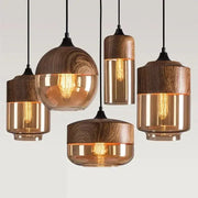 Amber glass and natural wood pendant light fixture with warm-toned bulbs for dining room pendant lighting