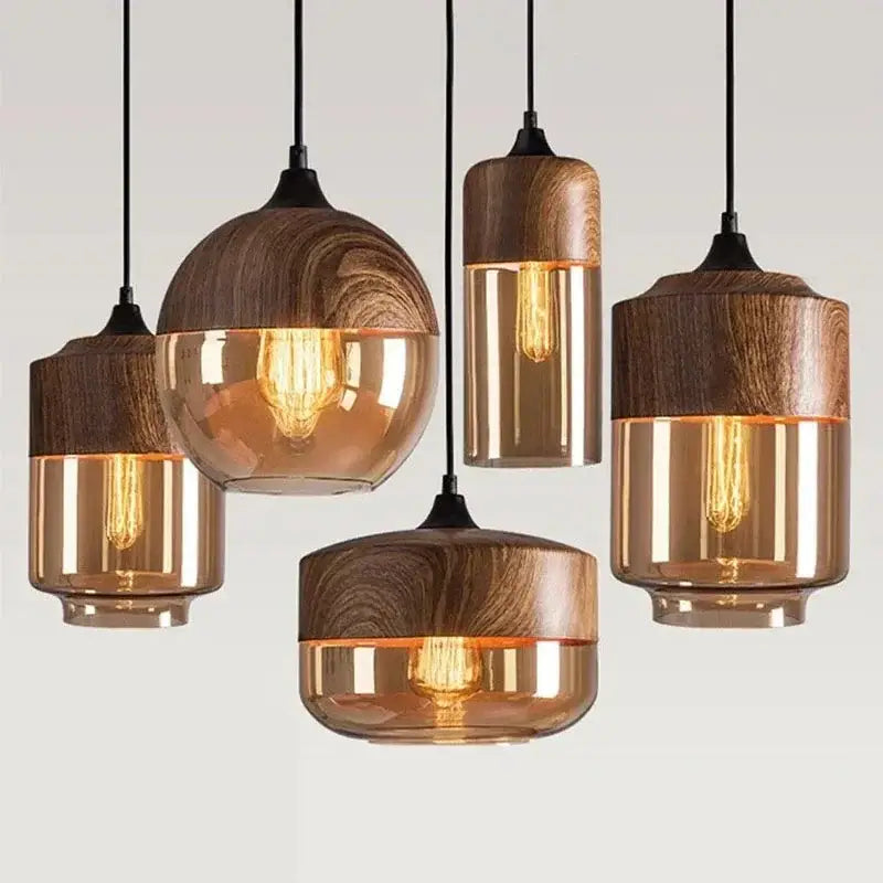Amber glass and natural wood pendant light fixture with warm-toned bulbs for dining room pendant lighting