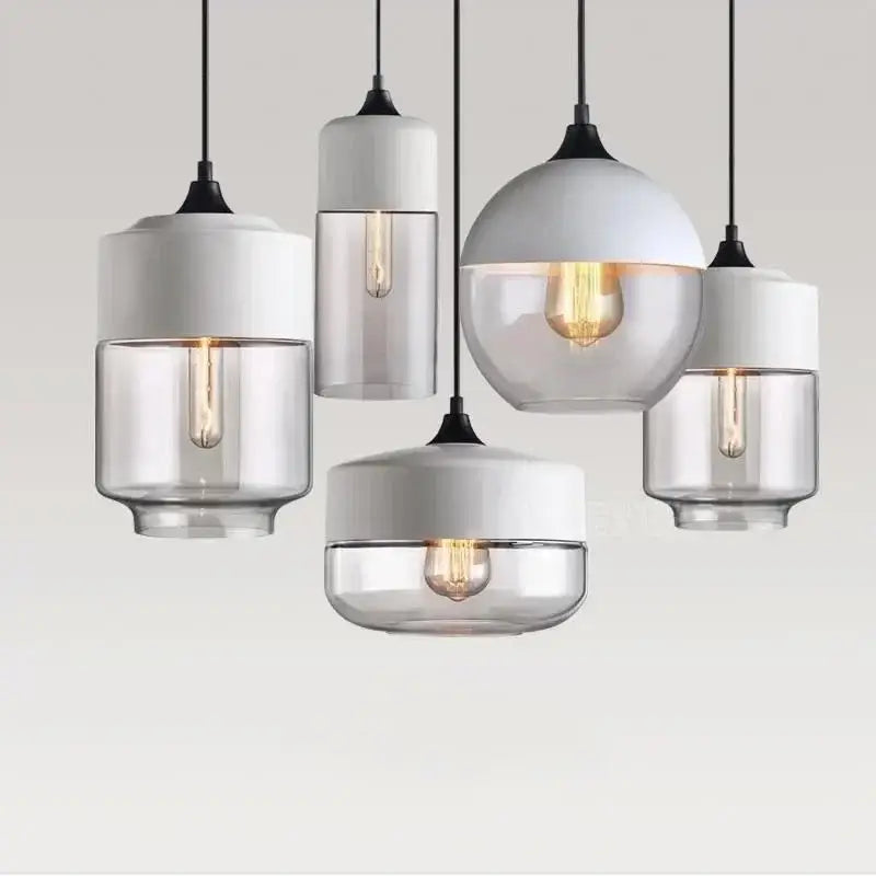 Modern pendant light fixture with amber glass shades, white ceramic tops, and warm filament bulbs for dining room