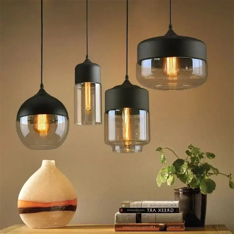 Modern black and clear glass pendant light fixture with exposed filament bulbs for dining room ambiance