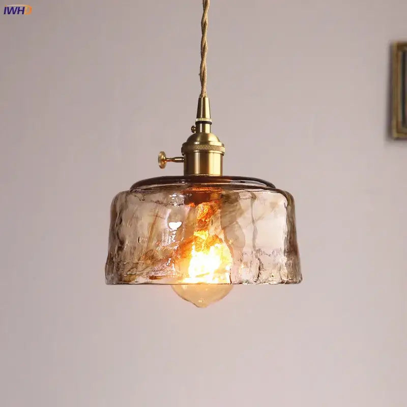 Amber glass copper pendant lights with warm-toned textured glass and brass fixtures for dining room use