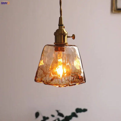 Warm amber-colored textured glass copper pendant lights with brass fixtures four piece set for dining room