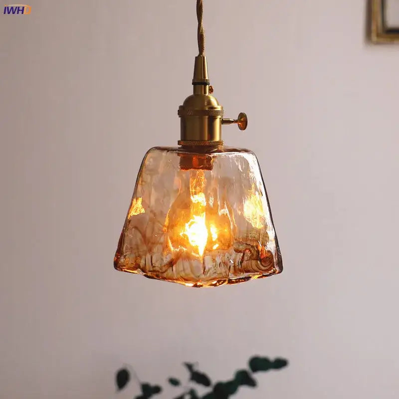 Warm amber-colored textured glass copper pendant lights with brass fixtures four piece set for dining room