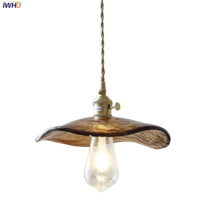 Amber glass pendant light with brass knob switch and twisted cord for dining room decor featuring decorbites brass knob