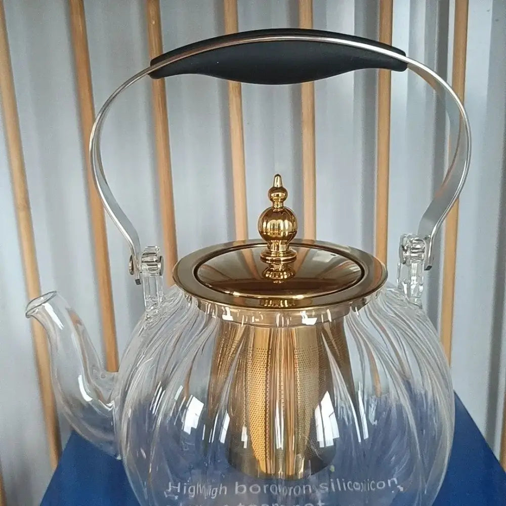Clear glass teapot with gold-toned lid handle spout and mesh infuser from decorbites amber glass teapot collection