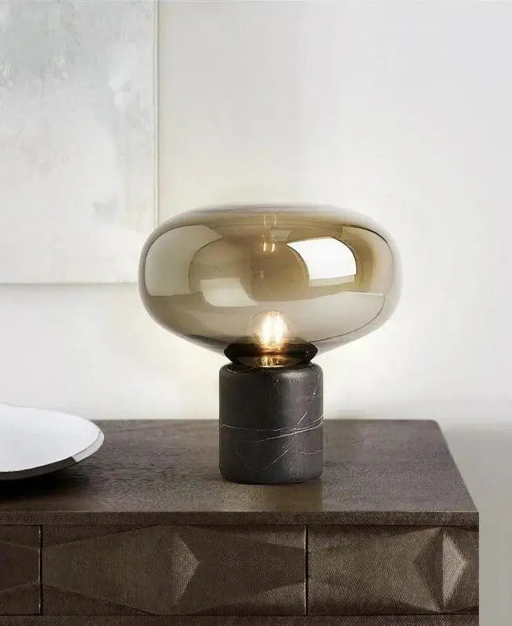 Amber nordic table lamp with a sleek amber-tinted glass shade and matte black marble base for modern table lighting
