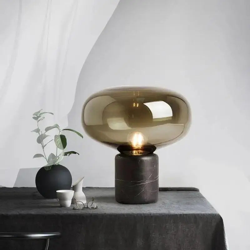 Amber nordic table lamp with sleek amber-tinted glass dome and dark marble base for elegant nordic table decor