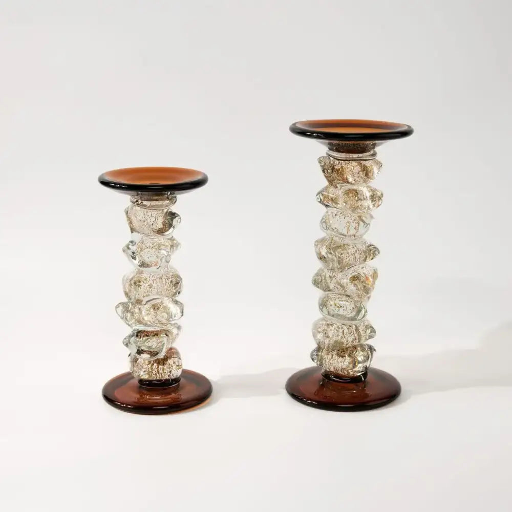 A pair of clear glass splicing candelabrum with amber twisted bases and tops featuring a stacked bubble design