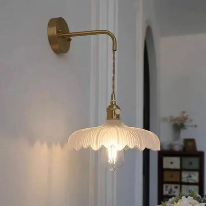 Off-white petal-shaped glass lampshade with brass arm in decorbites amber vintage led wall light for hallway use