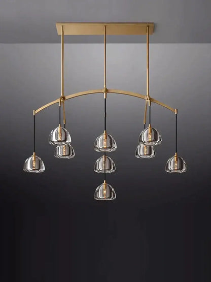 Gold-toned american copper crystal chandelier with clear glass pendant shades and curved minimalist design for living room decor