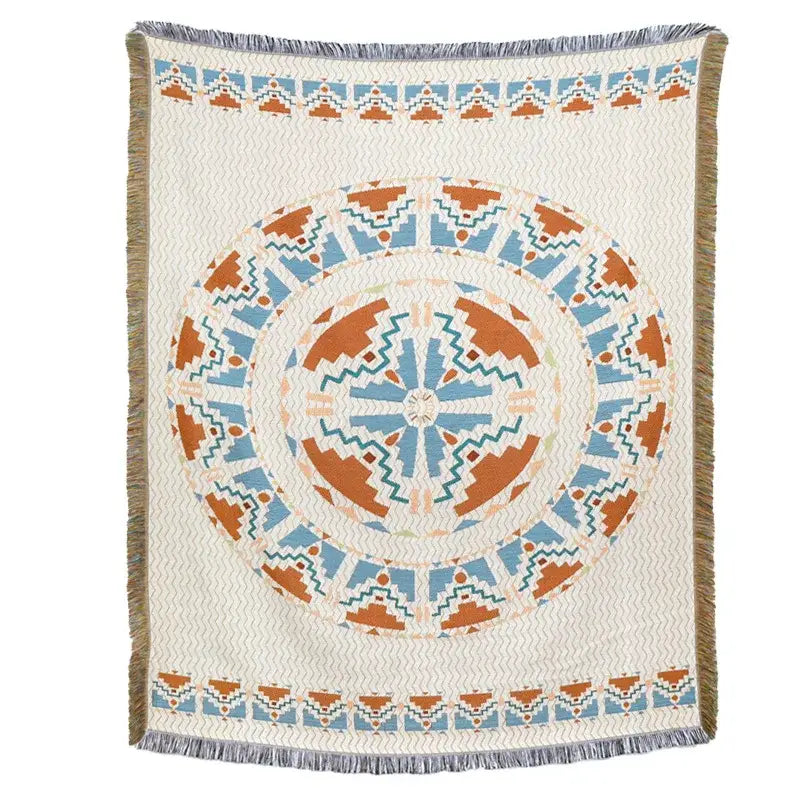 A cream-colored woven blanket sofa cover with terracotta teal mandala and fringe american country plaid style