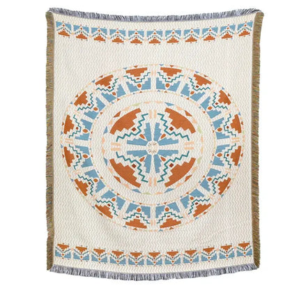 A cream-colored woven blanket sofa cover with terracotta teal mandala and fringe american country plaid style