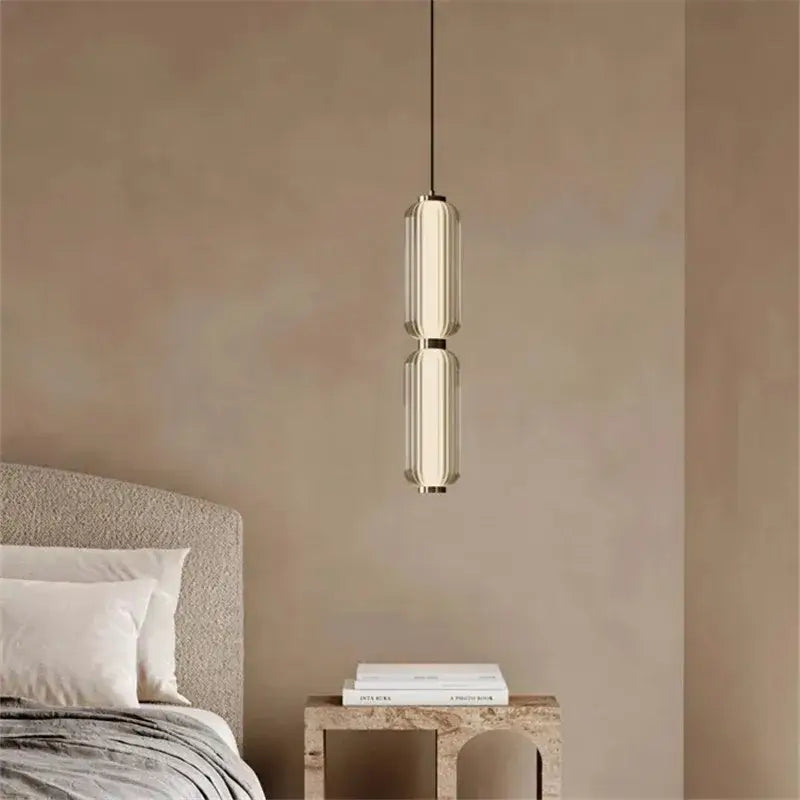 Modern minimalist glass staircase pendant light with two stacked frosted glass shades and brushed brass accents for dining room