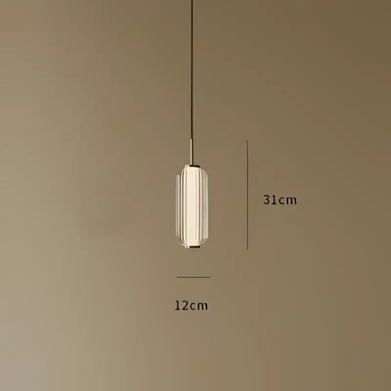 A sleek american retro frosted glass staircase pendant light with cylindrical glass shade and metallic accents for dining room