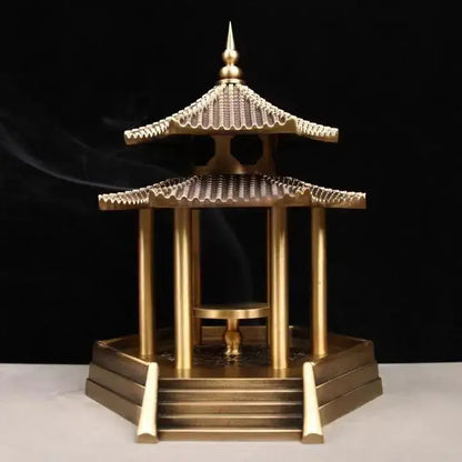 Golden brass incense burner shaped like a traditional chinese pavilion with intricate roof details and steps for decor