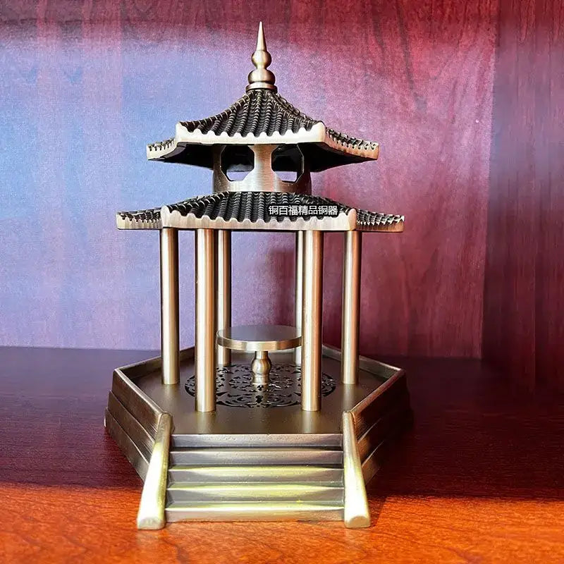 Brass incense burner shaped as an ancient pavilion with tiered roof and ornate detailing for living room decor