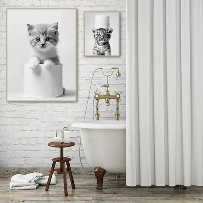 White porcelain clawfoot bathtub with ornate brass fixtures featured in decorbites bathroom wall art cute animal canvas posters