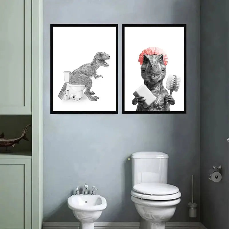 Two framed black-and-white canvas paintings featuring dinosaurs in funny bathroom scenes with toilet paper accents