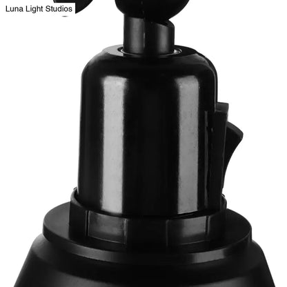 Black plastic camera mount with cylindrical body and textured grip shown with decorbites™ wrought iron direct wired wall sconce