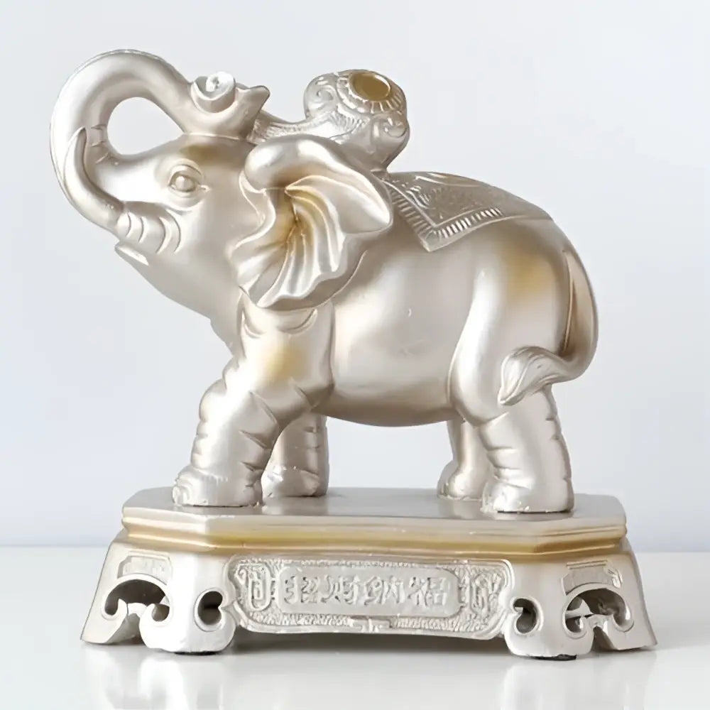 Silver elephant couple resin figurine with intricate detailing and golden accent on ornate base for living room decor
