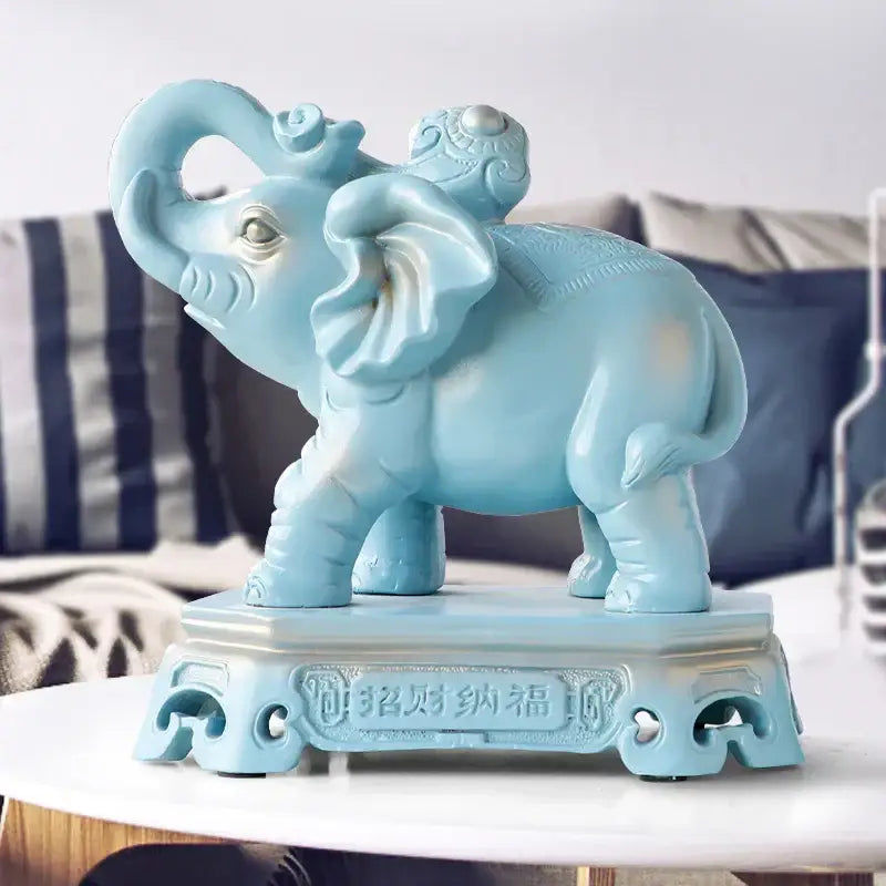 A light blue ceramic elephant couple resin statue with intricate carvings and chinese character base for living room decor