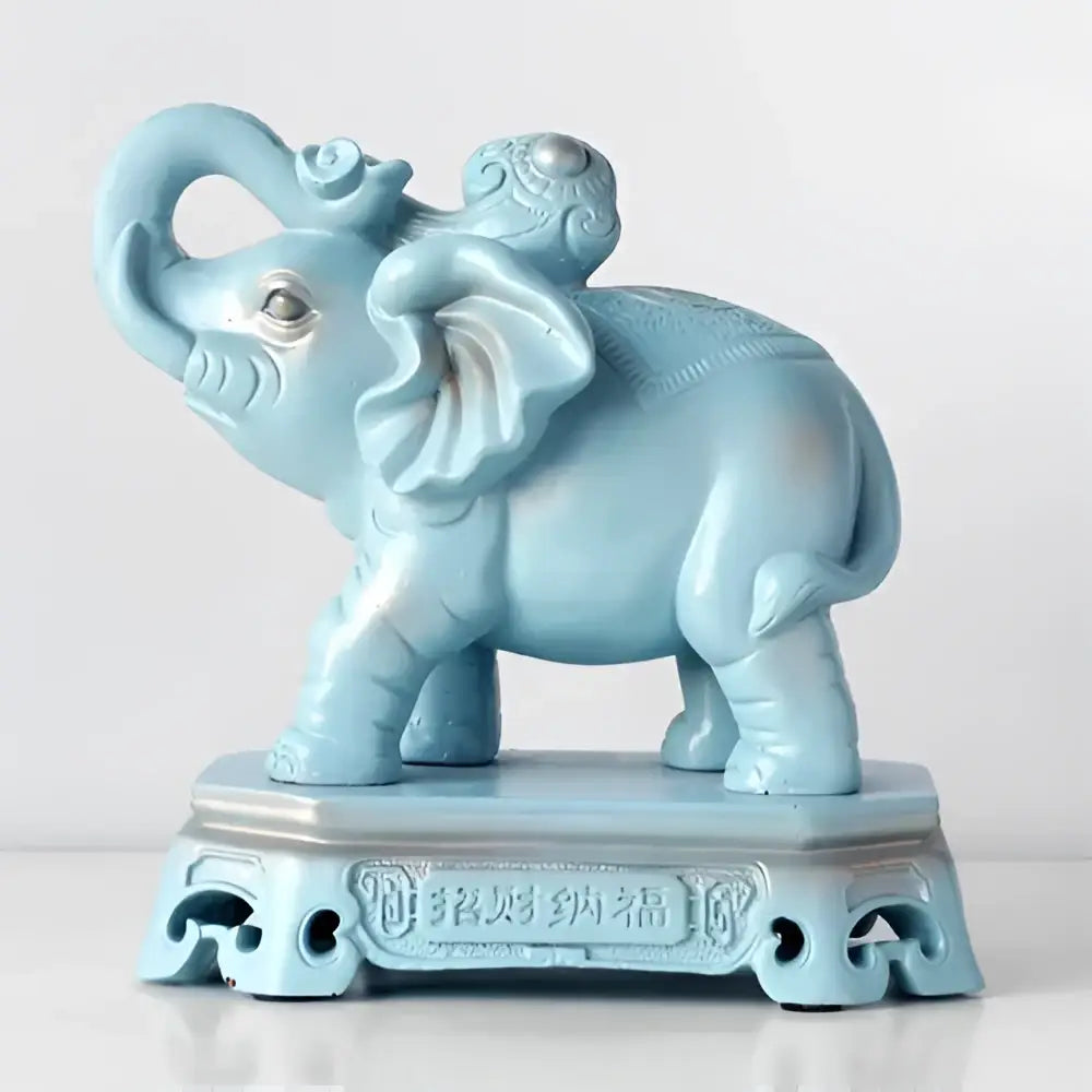 Light blue ceramic elephant couple resin statue with intricate carvings on decorative base for living room decorbites decor