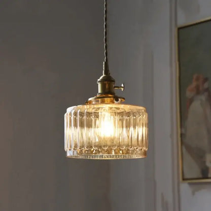 Antique brass and amber glass led pendant light with warm-toned ribbed glass and twisted cord for stairs lighting