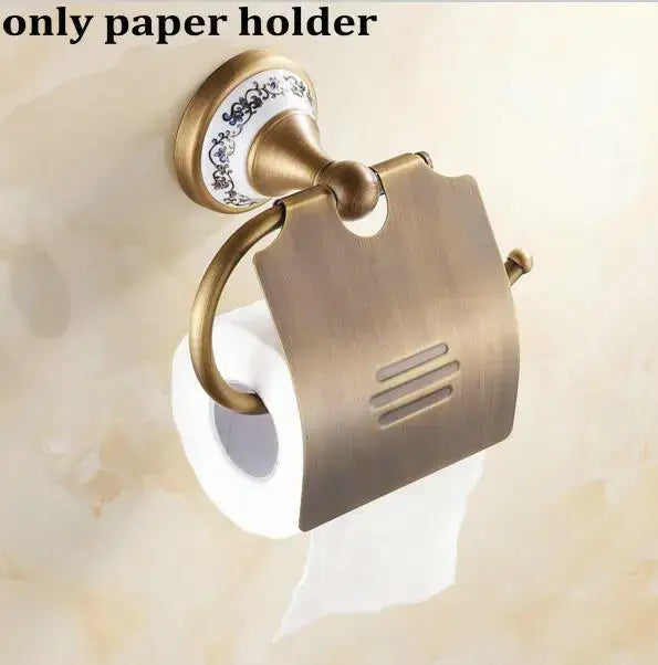 Antique brass toilet paper holder with ornate ceramic base and decorative metal cover from decorbites bathroom accessories set