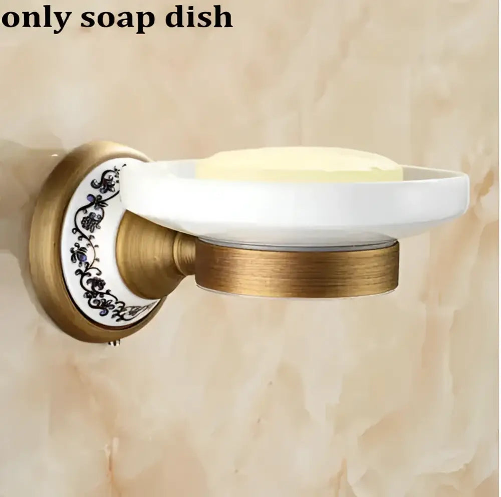 White ceramic soap dish with gold-toned metal bracket and black floral pattern from decorbites bathroom accessories set