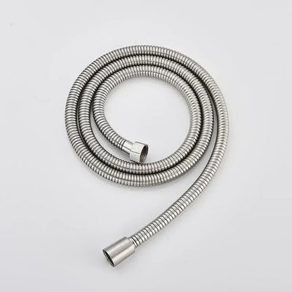 A coiled metallic silver flexible shower hose with ribbed texture for antique brass and chrome hand shower head bathroom sprayer