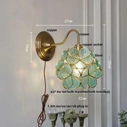 Antique brass wall sconce with a brass copper finish and teal clear glass flower-shaped shade for bedroom decorbites clear glass