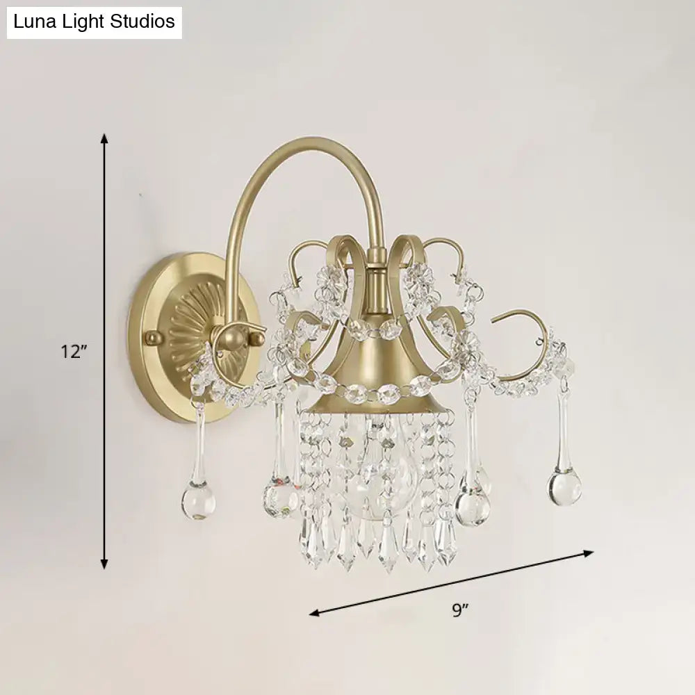 Antique brass and crystal teardrop wall light sconce featuring delicate gold-toned metal and cascading clear crystals