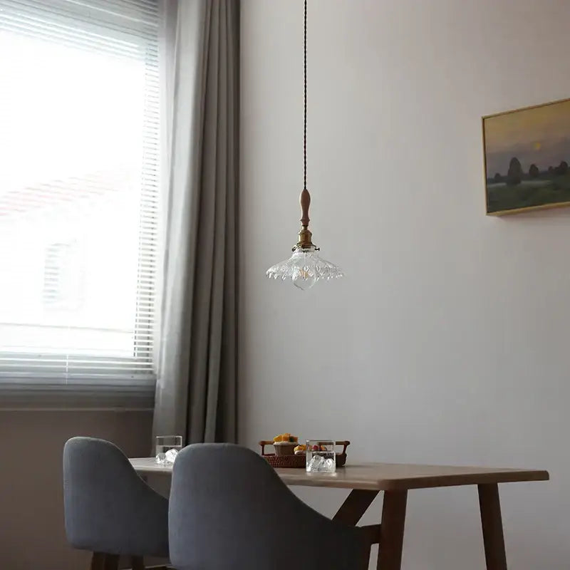 Antique brass and glass led pendant lamp featuring a delicate crystal pendant light with wooden top hanging from a black cord