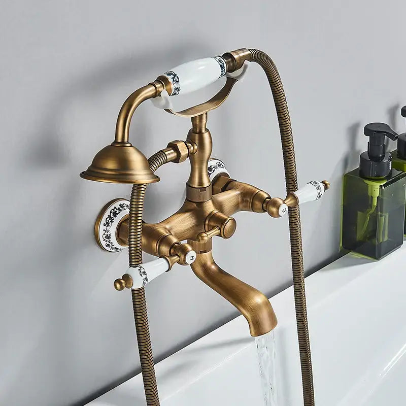 Antique brass and white ceramic bathtub shower faucet set with black floral pattern handles for bathroom use