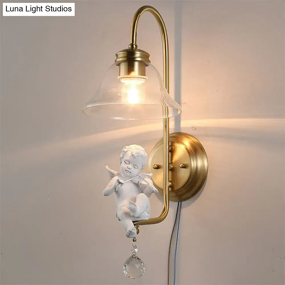 Antique brass angel glass sconce light with a white angel figurine and clear glass shade for bedroom wall lamp