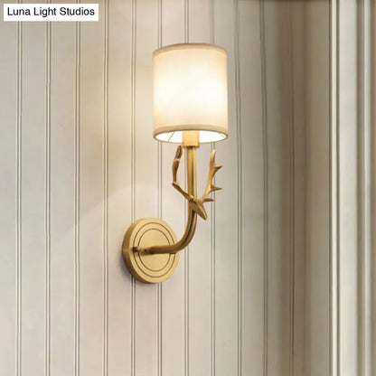Antique brass antler wall sconce with gold-toned design and off-white fabric shade for stylish bedroom lighting