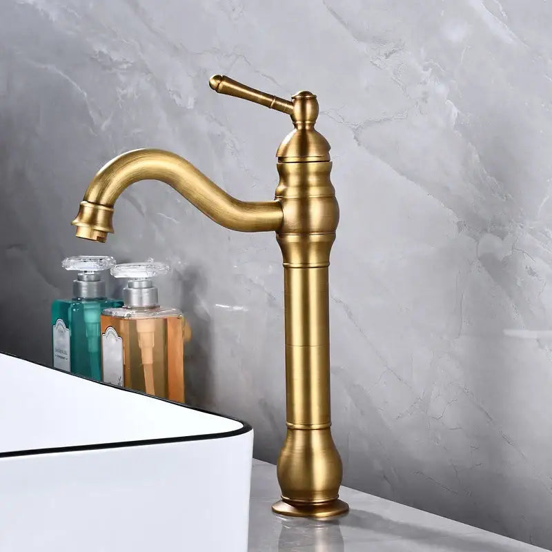 Antique brass basin faucet with single handle and curved spout featuring a vintage decorbites brass basin design