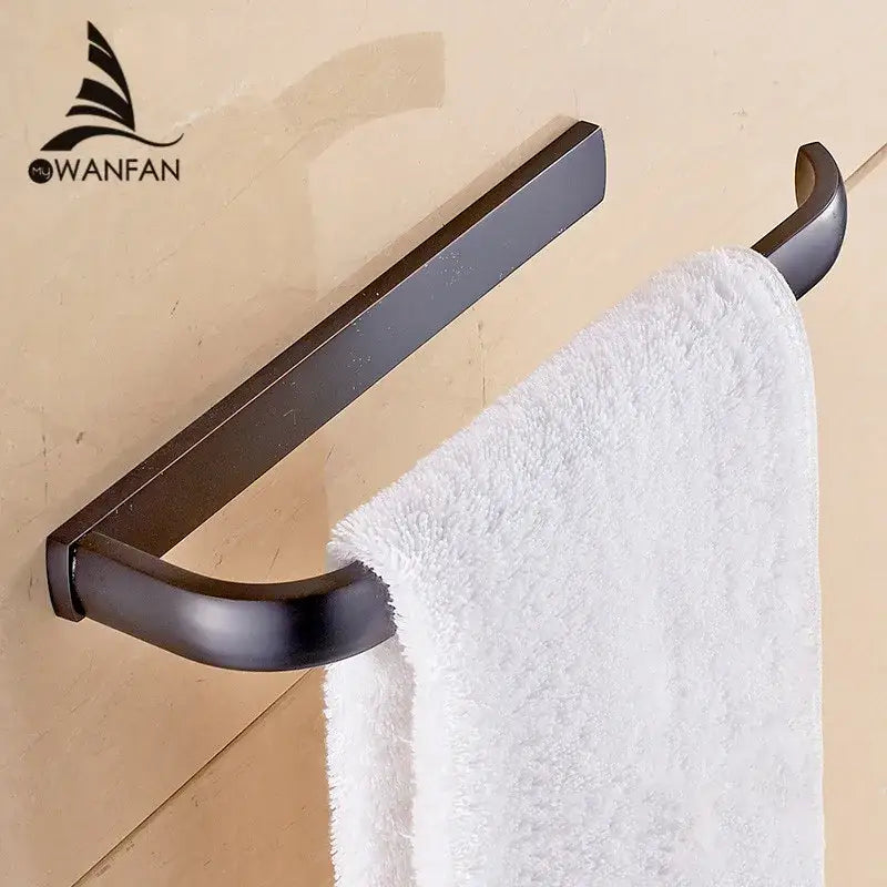 Bronze-finished metal towel rack holding white plush towel from decorbites brass bathroom accessories set with towel rings